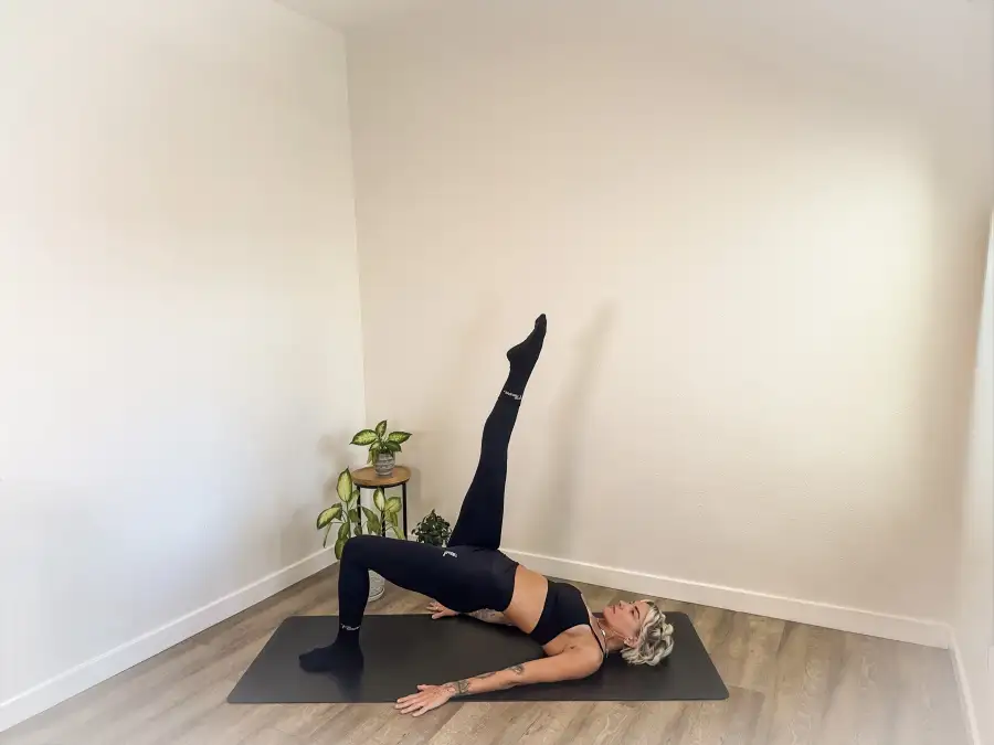 Athlete stretching on a mat in socks