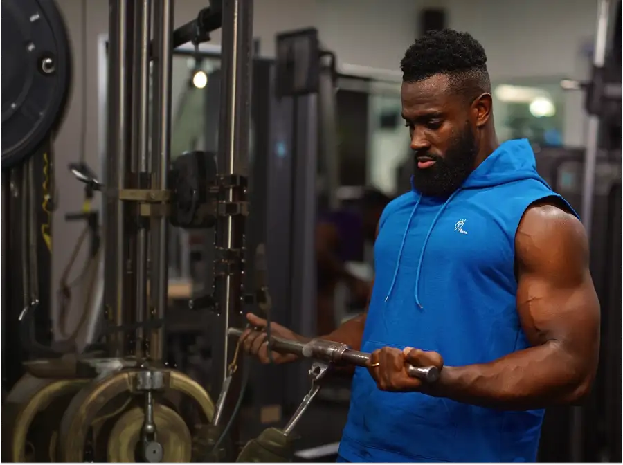 Athlete training on a cable machine in the gym